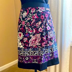 New York & Company black, fuchsia, purple and blue print wrap skirt. Size 10